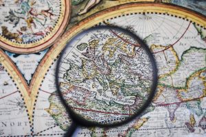 close-up-magnifying-glass-colorful-ancient-map